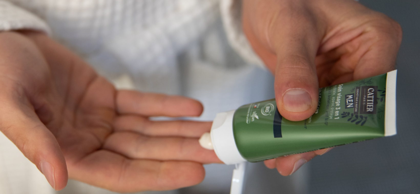 Visuel d'un homme versant du soin visage 3 en 1 homme Cattier dans sa main 